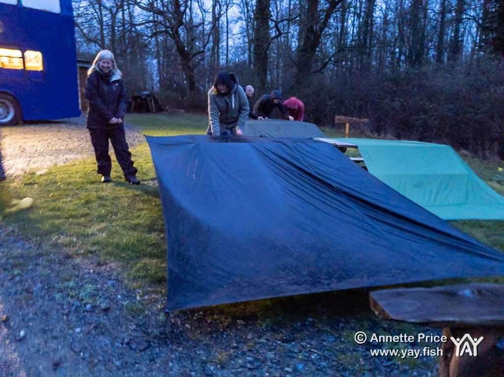 Setting up tarps in the rain..